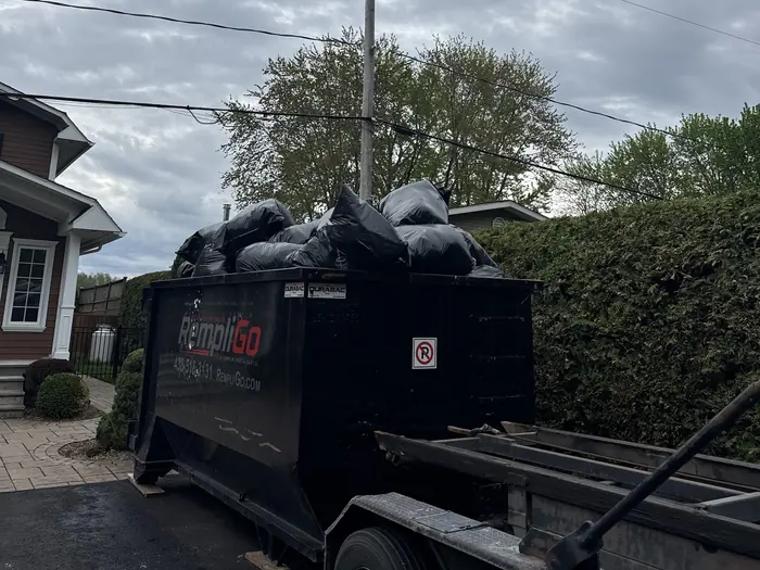 Example of an overfilled dumpster: bags stacked above the top of the walls